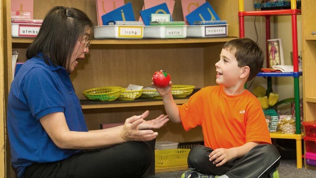 Young boy learning at the primary Montessori programs.